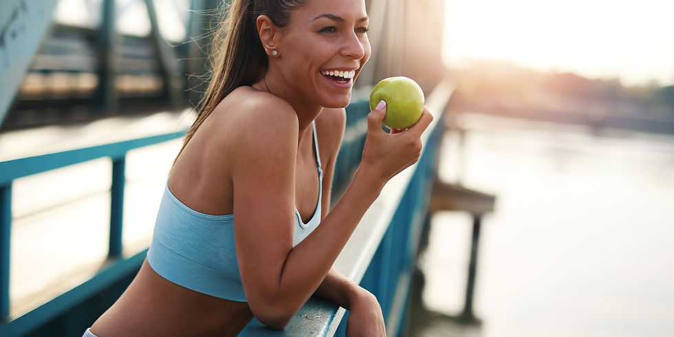 woman smiling eating an apple focusing on preventative health