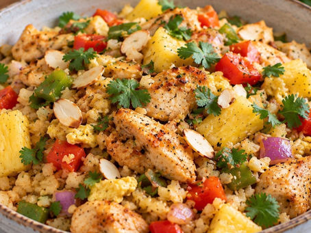 Pineapple chicken cauliflower fried rice with bell peppers, egg, almonds, lime and fresh cilantro.
