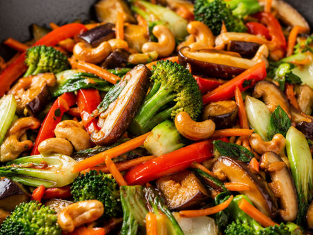 Chinese vegetable stir fry with bok choy, broccoli, carrots, bell pepper, shiitake mushrooms, eggplant, and cashews.