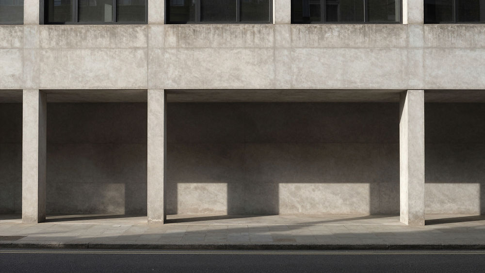 Concrete building facade with geometric shadows