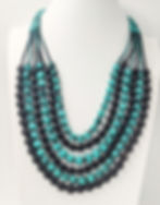 Front view of a unique, mint-and-black sari silk necklace made from upycled saris wrapped around wooden beads
