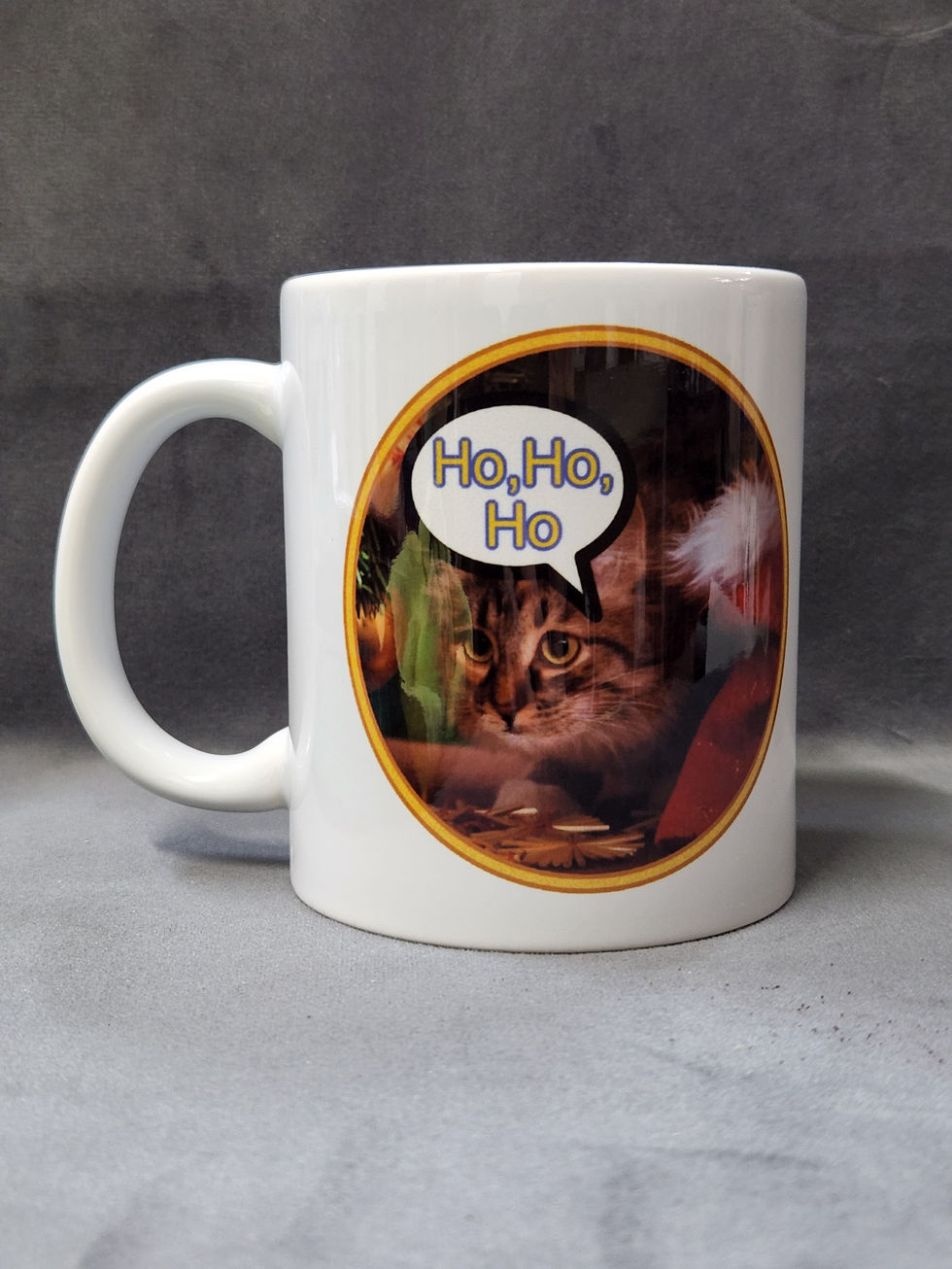 White mug with "Ho, Ho, Ho" text and a festive background with a cute kitten.