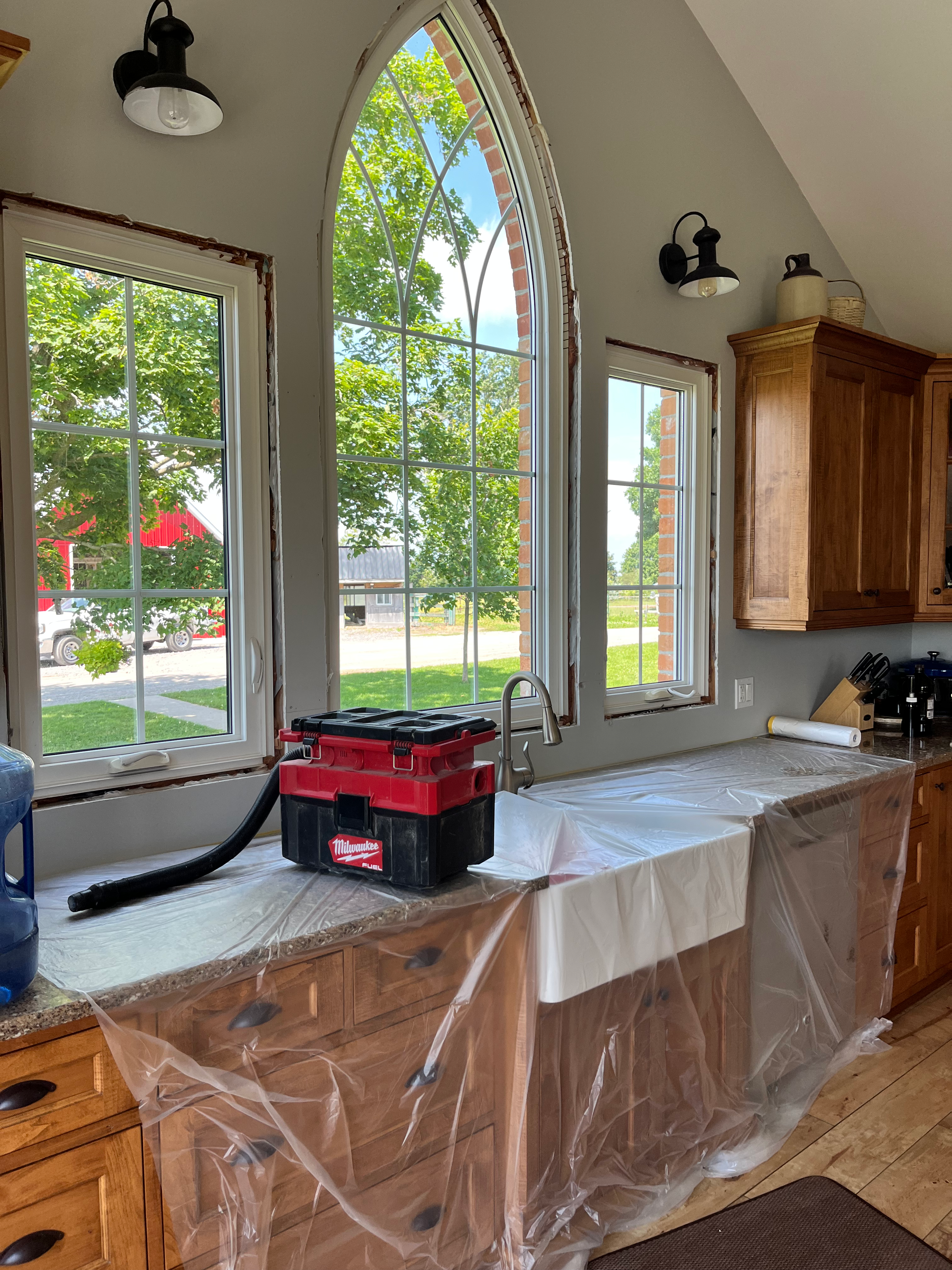Arched window casing being fitted above a protected countertop