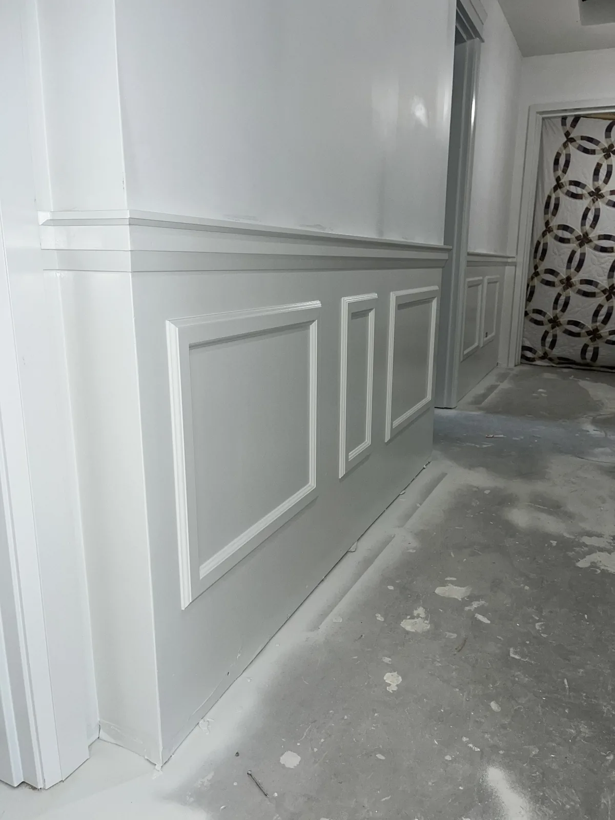 Painted wall panels and chair rail meeting the door casing