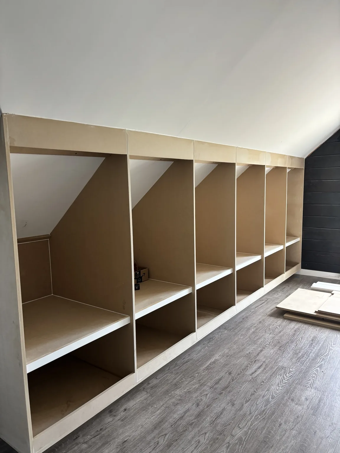 Open cabinet boxes and shelves fitted beneath the roof slope