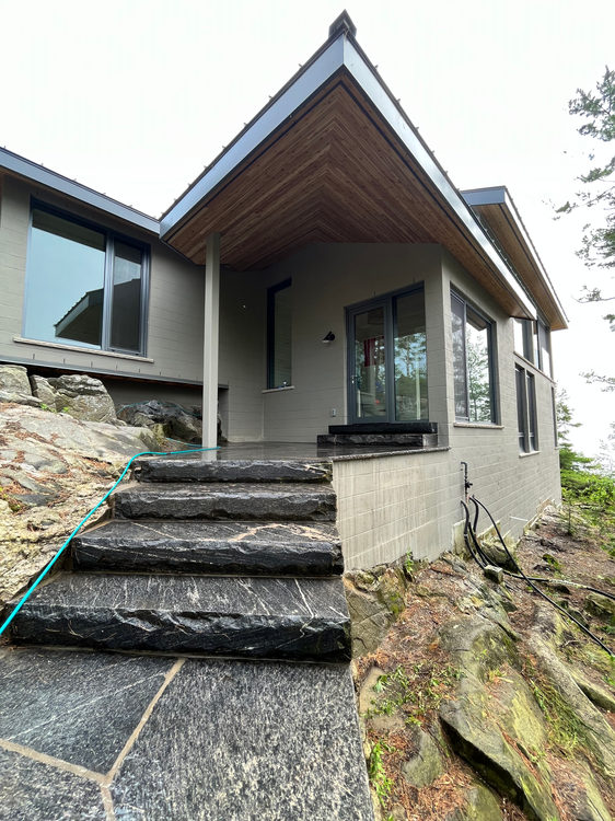 Completed gabled porch ceiling viewed from the stone steps
