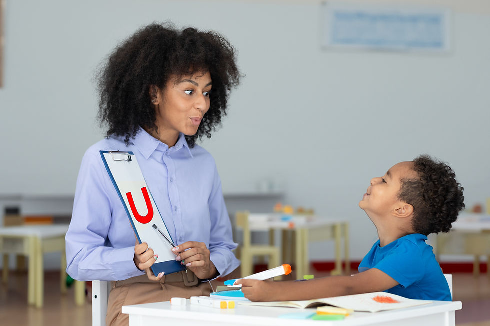 professional-female-speech-therapist-working-with-little-boy-learning-pronounce-letters.jp