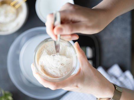 hands stirring sourdough