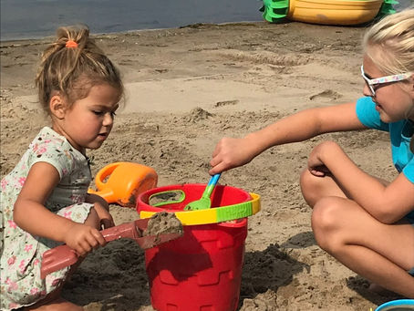 two girls building a sandcastle