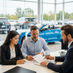 co-signer and main borrower signing car loan documents with lender at dealership in Canada