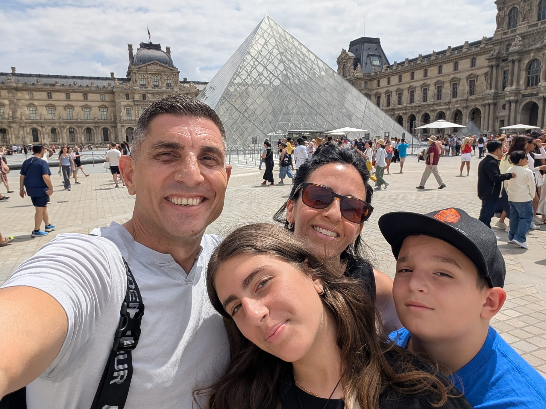 A detailed portrait view of the Louvre pyramid reflecting the morning light.