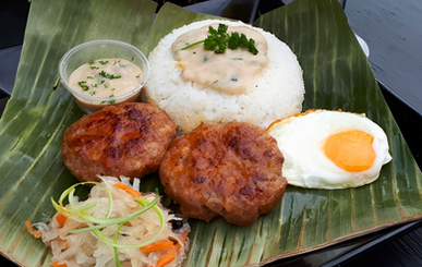 Two pork burgers on rice, companied with a fried egg, side pickled papaya, and creamy gravy sauce.