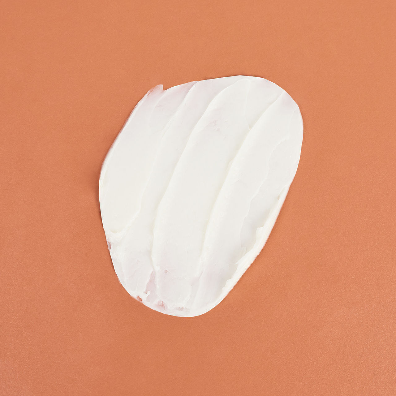 Facial cream on an orange background