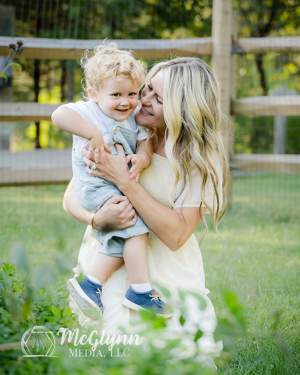 Mother smiling at toddler son, who is giggling.