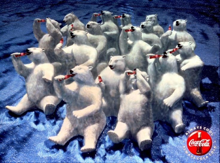 Polar bears sit on icy terrain, joyfully drinking red Coke bottles. Blue backdrop suggests a cold environment. Coca-Cola logo visible.