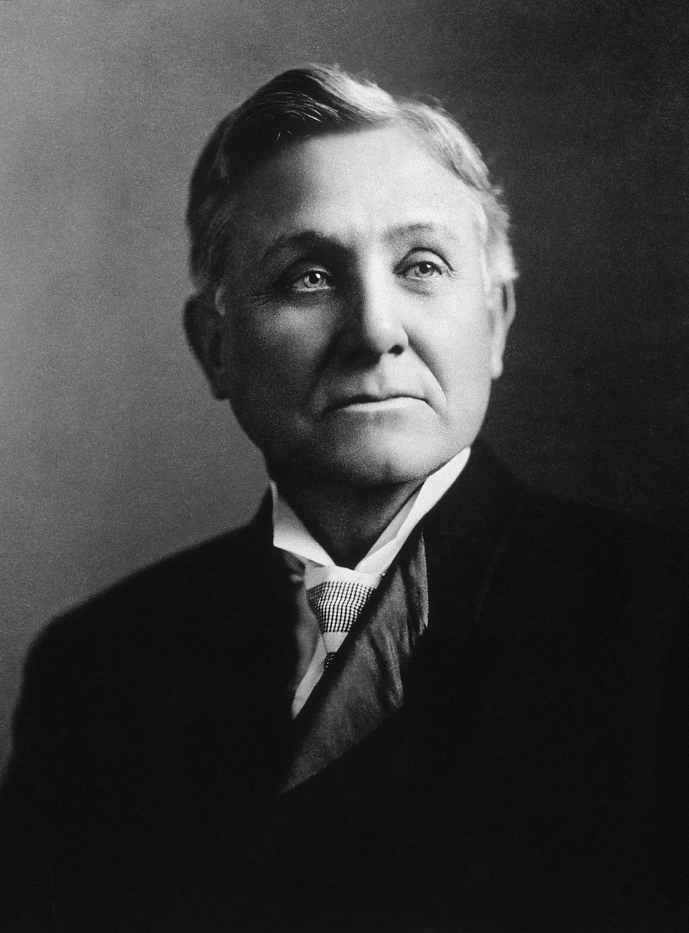 Elderly man, Asa Candler, in a suit with a tie, looking contemplatively to the side. Black and white portrait with a neutral background.