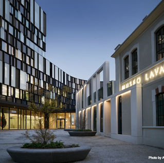 entrance of the Lavazza museum building in Turin, the brand visitor centre and experience where tours happen, housed in a modern curving glass and stone building