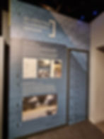 Exhibit panel at the Silverstone Museum titled "Silverstone T2 Aircraft Hangar" with text about its history and refurbishment, featuring photos and diagrams on a blue background.