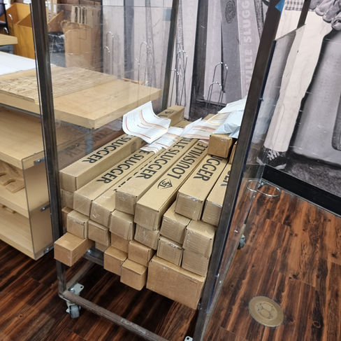 baseball bat boxed up on a cart in a factory