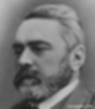 Black and white portrait of a man, alec walker, with a thick beard and neatly combed hair, wearing a suit and tie. Serious expression.