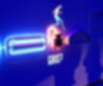 Neon wall art shows a figure running with "GRIST" text. Blue and pink outlines a vibrant, energetic mood. Shadows cast on the wall. This is a model at the johnnie walker princes street visitor experince.
