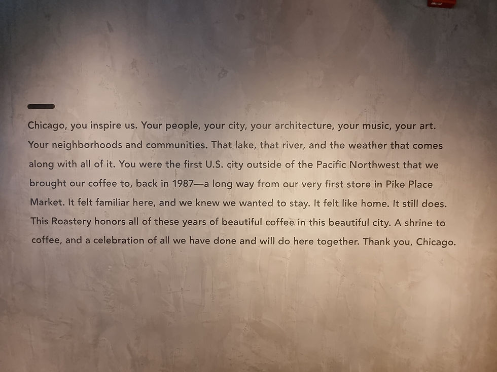 Text on a textured wall expresses admiration for Chicago, mentioning its people, culture, and significance to a coffee roastery.