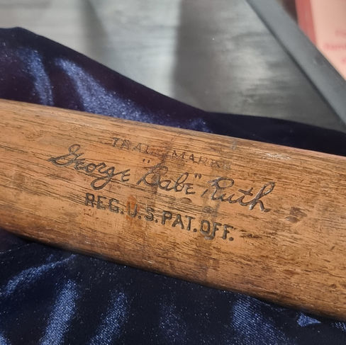 close up of a baseball bat with the signature of babe ruth etched into it