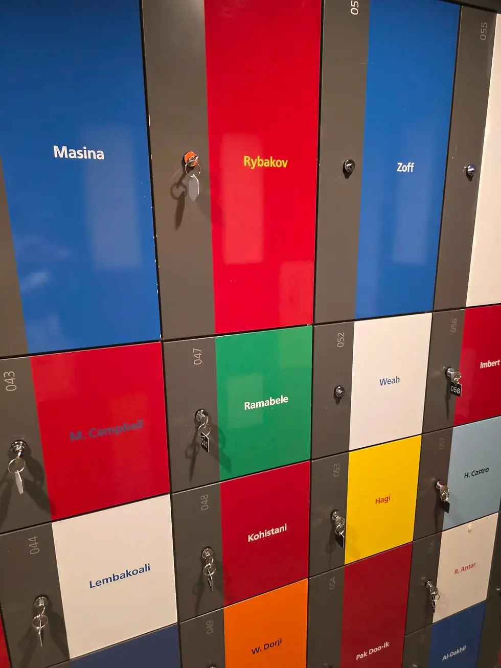 Colorful locker wall at the FIFA museum with keyed doors labeled Masina, Rybakov, Zoff, Ramabele and others, creating a neat institutional feel.