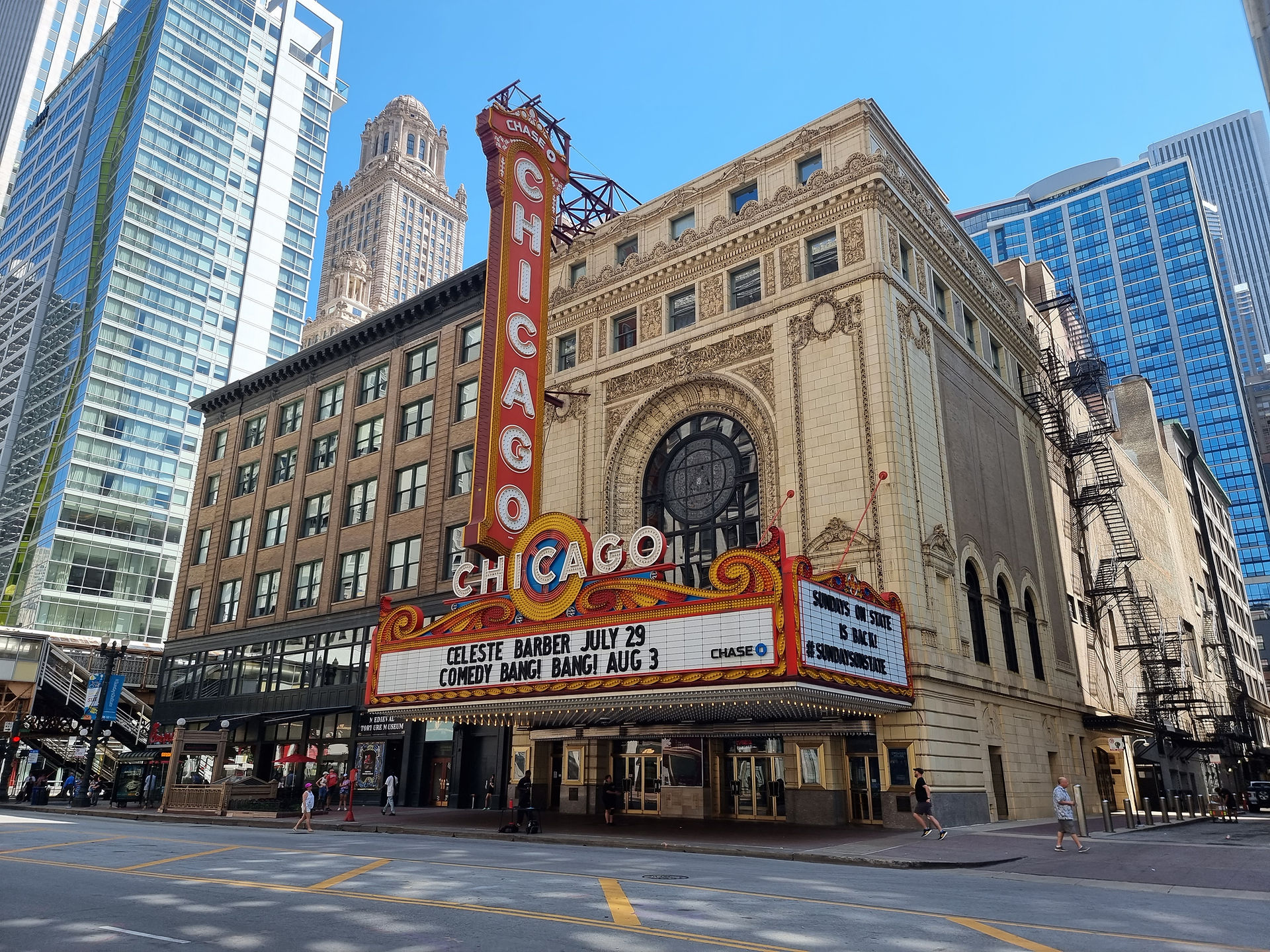 exterior of the chicago theatre, with a red and white sign saying chicago and advertising the shows