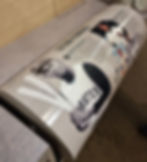 Display about baseball pioneers featuring vintage photos and text, highlighting Roberto Clemente. Background is wooden with a soft light.