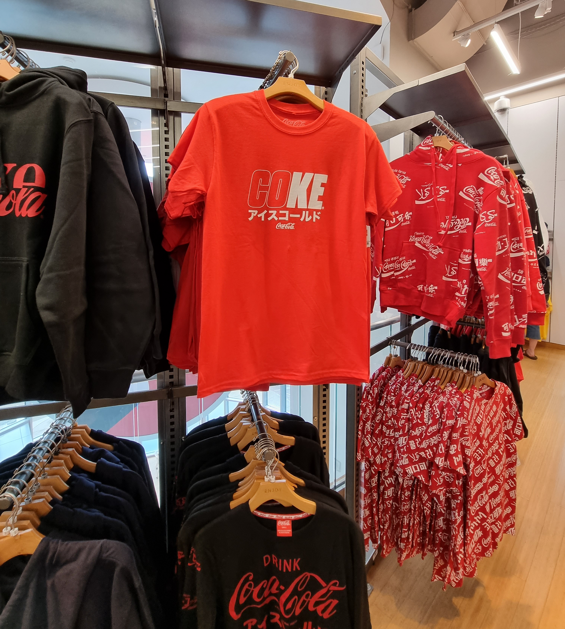 a selection of hanging garments branded in coca cola logo
