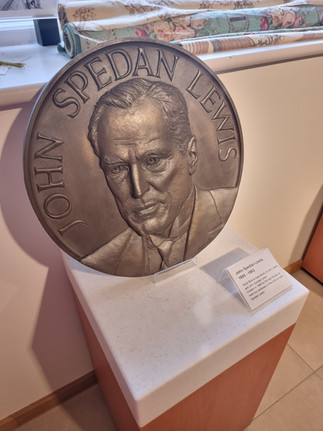 bronze circular plaque with face of john spedan lewis on it