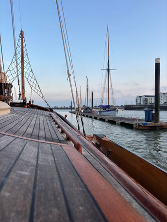 view from aboard Argovia, looking at heritage sailing smacks