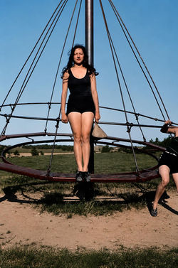Young Woman on Playground Climbing Structure
