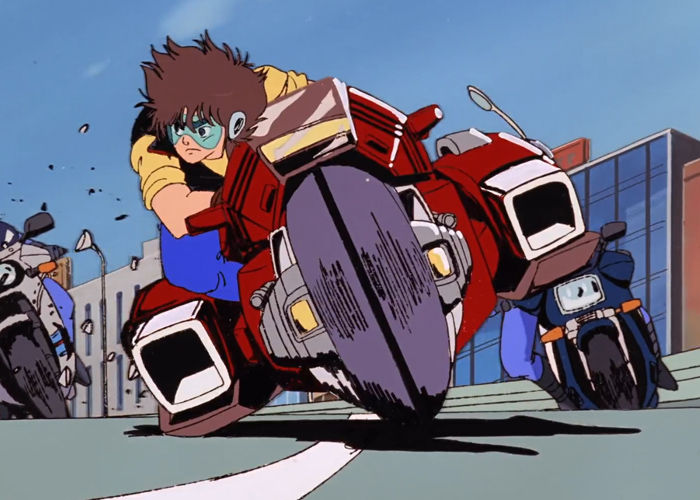 Shogo on the bike being chased by cops.
