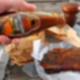 Close-up view of a bottle of classic BBQ sauce
