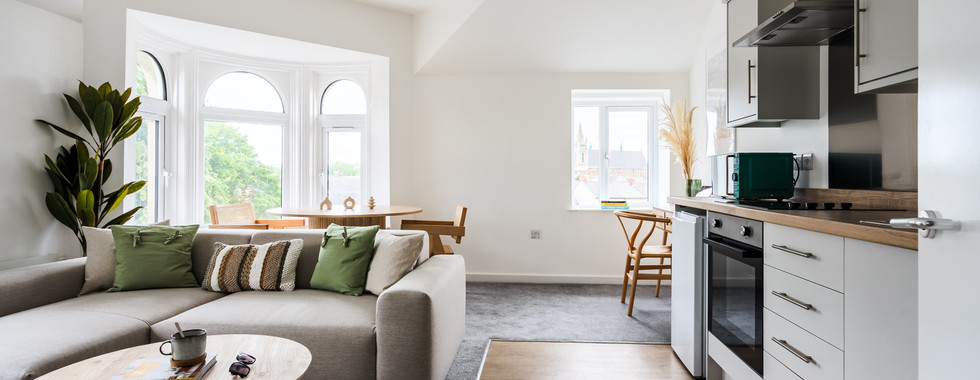 Inviting modern living room with warm, cozy decor, comfortable furnishings, and ambient lighting.