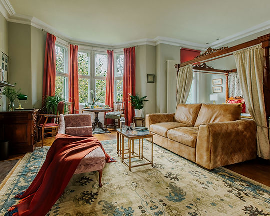 Four-poster bed and bay window at The Suite, 82 Cathedral Road, Cardiff