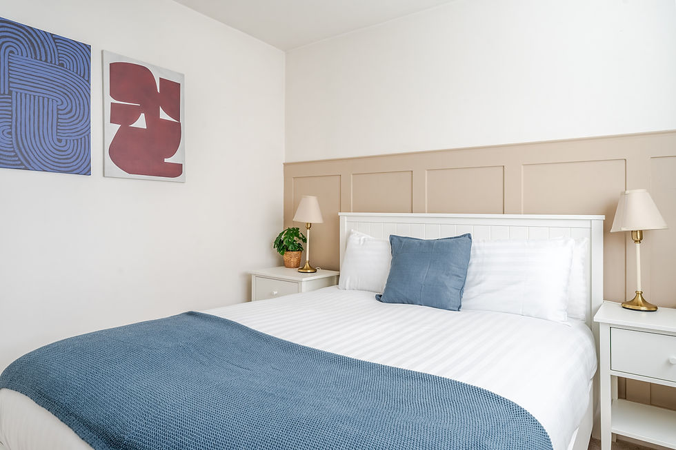 Bedroom 1: double bed against a panelled wall