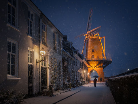 Wijk bij Duurstede in the snow early morning with a windmill in the netherlands.
