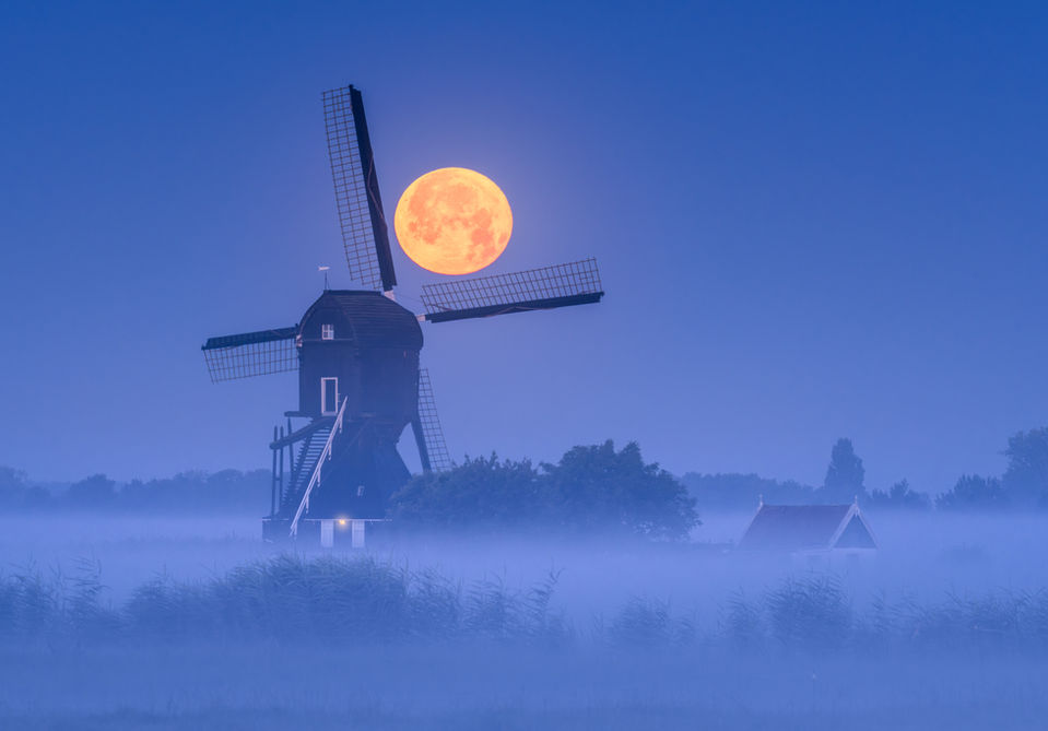 windmill with fog and a big moon