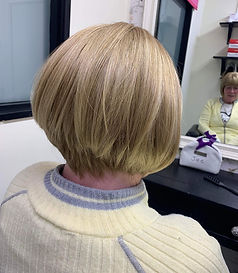 A woman with short blonde hair.