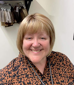 A smiling woman with short blonde hair