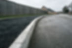 Newly laid asphalt on a pedestrian walk way leading to a new bungalow housing development