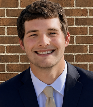 Michael Groce Head Shot with Brick Wall.png