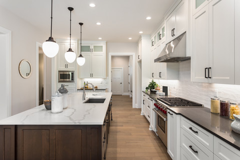 White kitchen with wood floor and kitchen island.