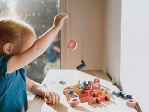 Toddler playing with block letters