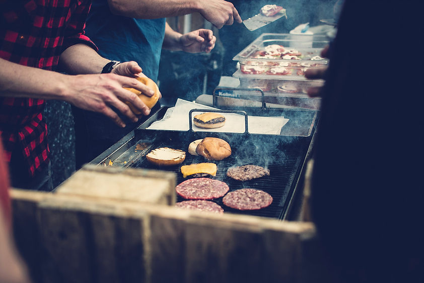 Burgers sizzling on a grill in the Fat Joes kitchen