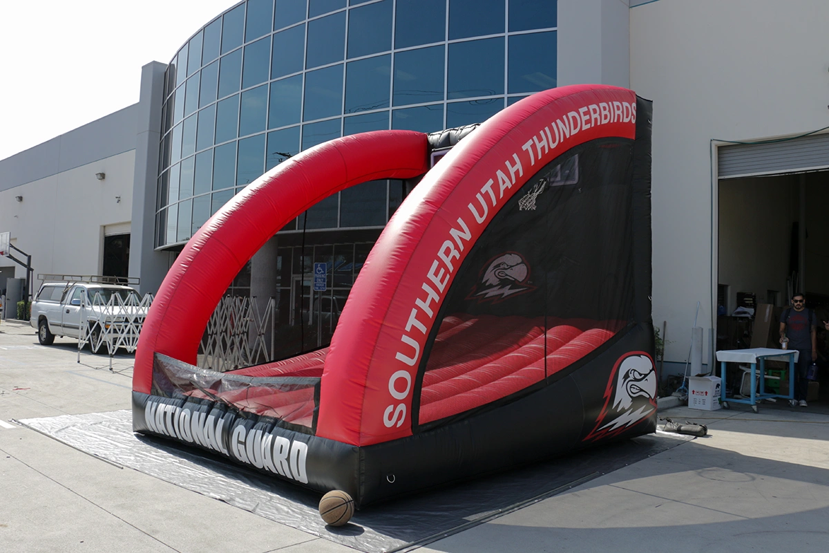 Custom inflatable basketball game with Southern Utah Thunderbirds branding at a sports event