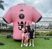 Large inflatable soccer jersey featuring Inter Miami branding, used as a fan photo op at a sports event.